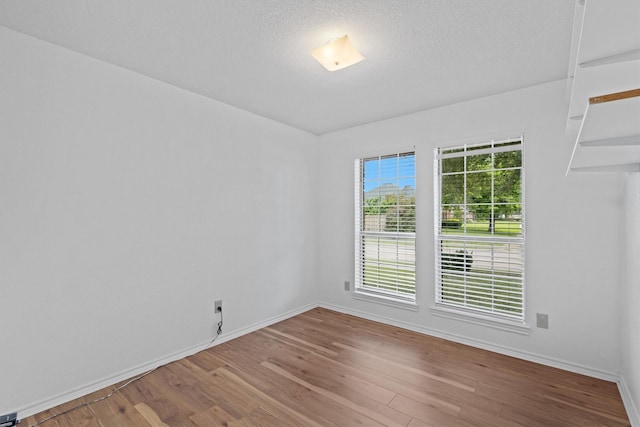 208 N Rustic Trl, Wylie, TX 75098 - empty room featuring wood finished floors, baseboards, and a textured ceiling