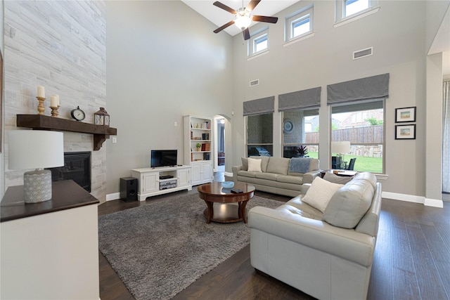331 Sagemeadow Rd, Wylie, TX 75098 - living room with a ceiling fan, a towering ceiling, a large fireplace, baseboards, and dark wood finished floors