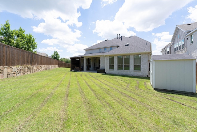 331 Sagemeadow Rd, Wylie, TX 75098 - rear view of property with an outbuilding, a storage unit, brick siding, a shingled roof, and a patio