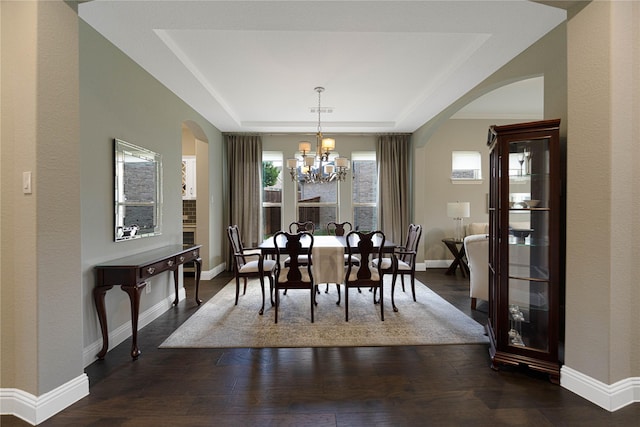 331 Sagemeadow Rd, Wylie, TX 75098 - dining room with arched walkways, a tray ceiling, a chandelier, and wood finished floors