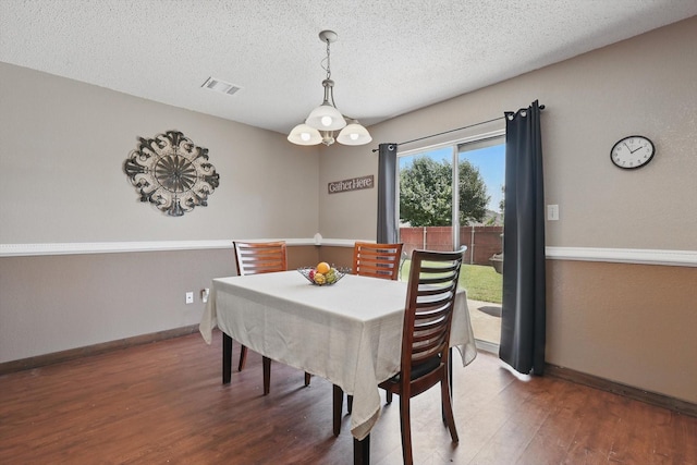 1554 Brandywine Ln, Little Elm, TX 75068 - dining space featuring wood finished floors, a textured ceiling, and baseboards