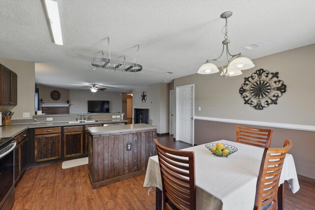 1554 Brandywine Ln, Little Elm, TX 75068 - dining space featuring dark wood-type flooring, ceiling fan, and a textured ceiling