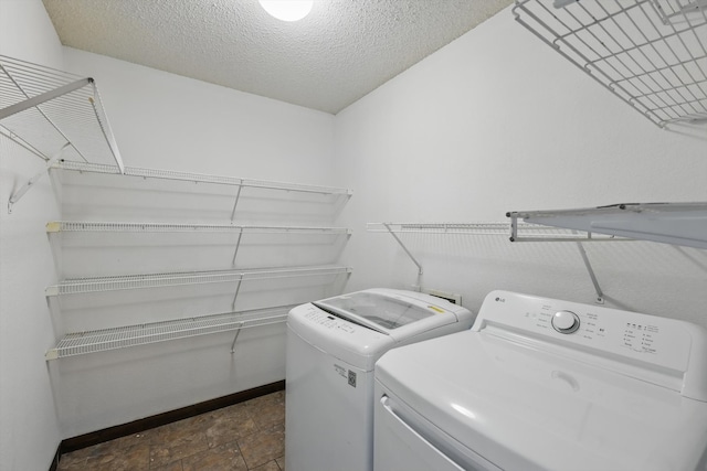 1554 Brandywine Ln, Little Elm, TX 75068 - clothes washing area with separate washer and dryer, baseboards, dark stone finish floors, and a textured ceiling