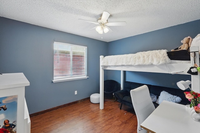 1554 Brandywine Ln, Little Elm, TX 75068 - bedroom with wood finished floors, a textured ceiling, baseboards, and ceiling fan