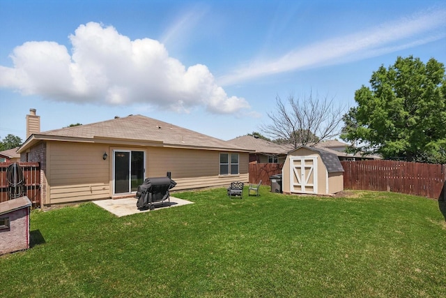 1554 Brandywine Ln, Little Elm, TX 75068 - back of property with a storage shed, an outbuilding, a patio area, and a chimney