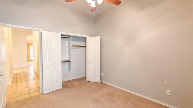 10252 Red Bluff Ln, Fort Worth, TX 76177 - unfurnished bedroom featuring light carpet, a ceiling fan, a closet, and light tile patterned flooring
