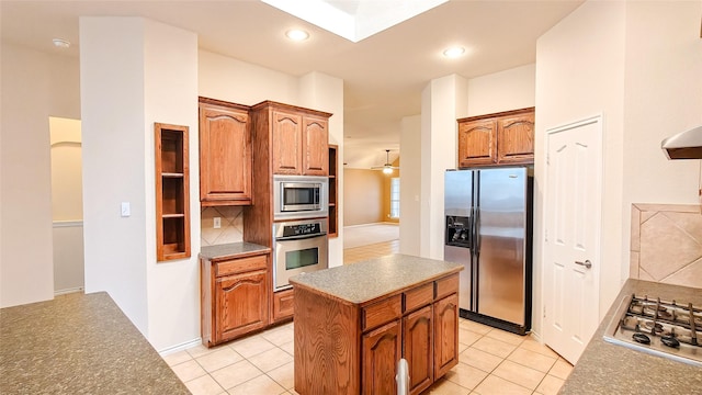 10252 Red Bluff Ln, Fort Worth, TX 76177 - kitchen featuring appliances with stainless steel finishes, light tile patterned floors, tasteful backsplash, a kitchen island, and recessed lighting