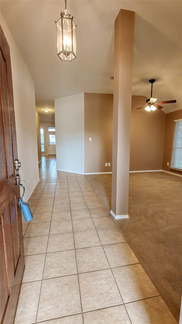 10252 Red Bluff Ln, Fort Worth, TX 76177 - corridor with light tile patterned floors and a chandelier