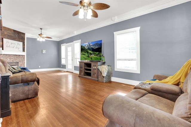 820 W Gandy St, Denison, TX 75020 - living room featuring a ceiling fan, a fireplace, wood finished floors, baseboards, and ornamental molding
