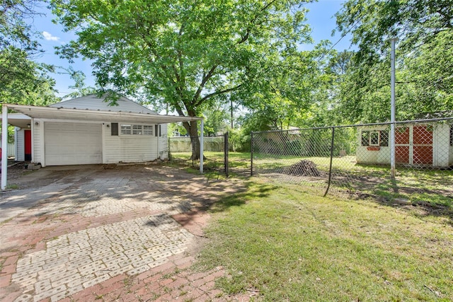820 W Gandy St, Denison, TX 75020 - view of yard featuring decorative driveway and an outdoor structure