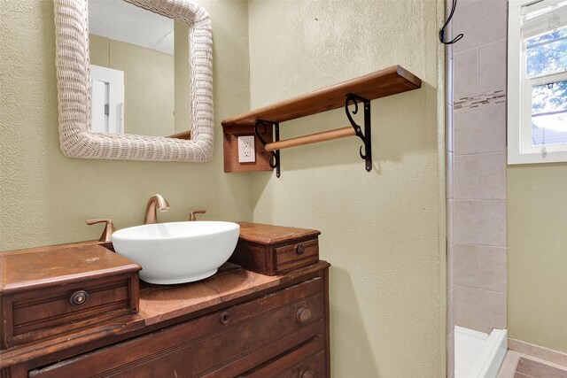 820 W Gandy St, Denison, TX 75020 - bathroom featuring tiled shower and vanity