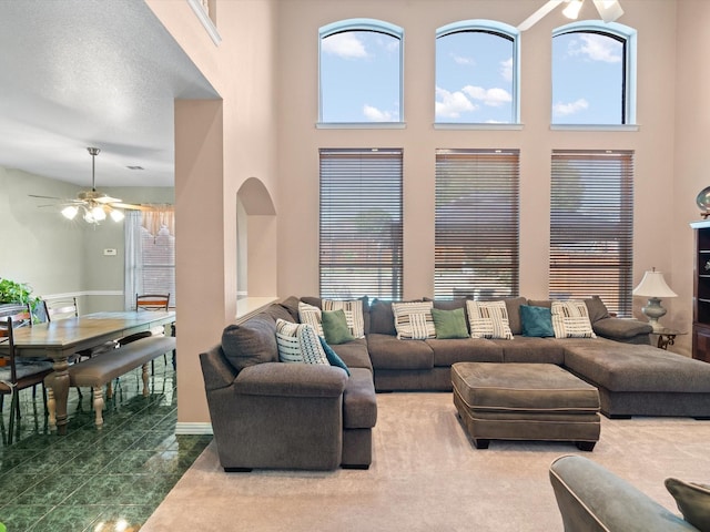 2105 Indian Trl, Rowlett, TX 75088 - living room featuring a ceiling fan, arched walkways, and a high ceiling