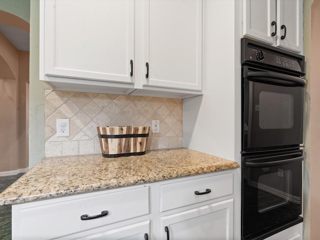 2105 Indian Trl, Rowlett, TX 75088 - kitchen featuring white cabinets, backsplash, and light stone countertops