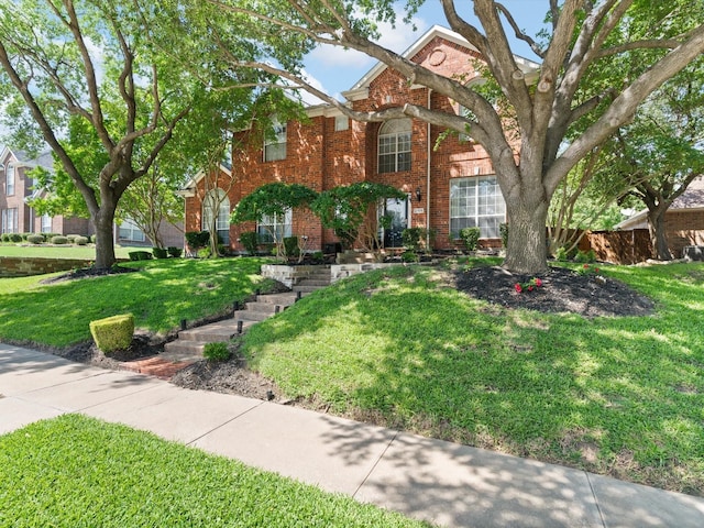 2105 Indian Trl, Rowlett, TX 75088 - traditional-style home with brick siding and a front yard