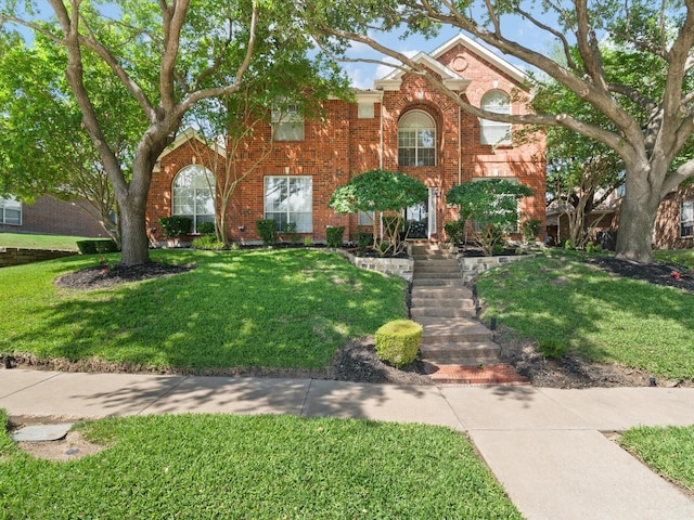2105 Indian Trl, Rowlett, TX 75088 - traditional-style house with a front yard and brick siding
