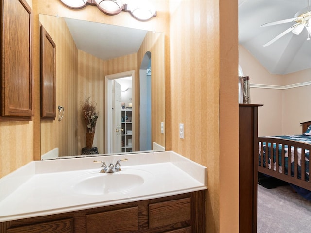 2105 Indian Trl, Rowlett, TX 75088 - bathroom featuring wallpapered walls, ceiling fan, vanity, and vaulted ceiling