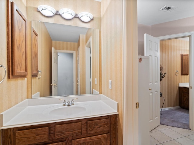 2105 Indian Trl, Rowlett, TX 75088 - bathroom featuring wallpapered walls, vanity, tile patterned flooring, and baseboards
