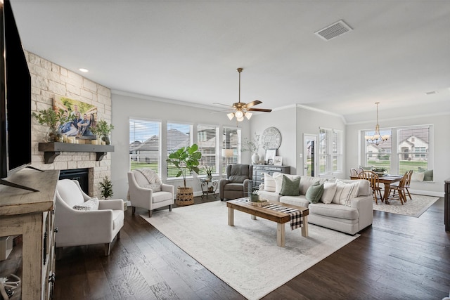 1037 Mickelson Dr, Granbury, TX 76048 - living room with crown molding, plenty of natural light, a fireplace, dark wood-type flooring, and a chandelier