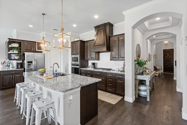 1037 Mickelson Dr, Granbury, TX 76048 - kitchen with stainless steel appliances, a sink, custom range hood, dark brown cabinetry, and open shelves