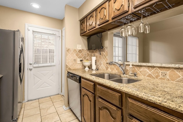 14333 Preston Rd Unit 2403, Dallas, TX 75254 - kitchen featuring stainless steel appliances, a sink, backsplash, and light tile patterned floors