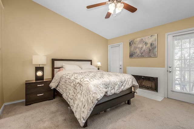 14333 Preston Rd Unit 2403, Dallas, TX 75254 - bedroom featuring light carpet, access to outside, lofted ceiling, ceiling fan, and a fireplace with flush hearth