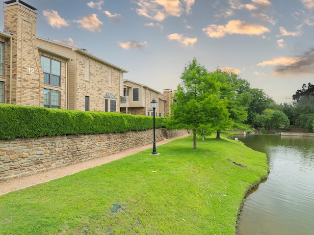 14333 Preston Rd Unit 2403, Dallas, TX 75254 - view of property's community with a water view and a lawn