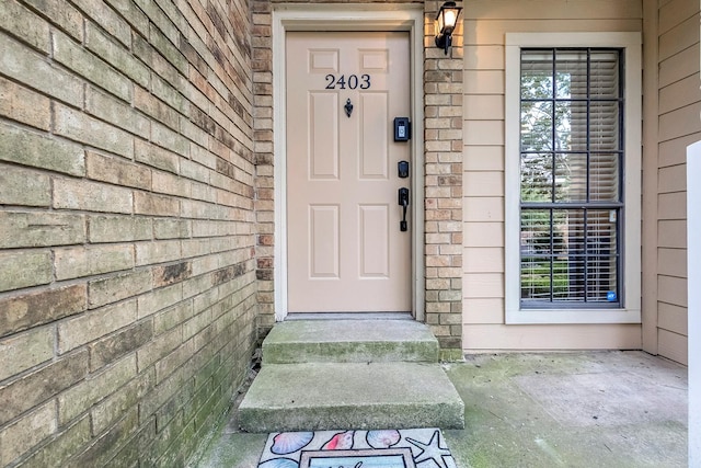 14333 Preston Rd Unit 2403, Dallas, TX 75254 - doorway to property with brick siding
