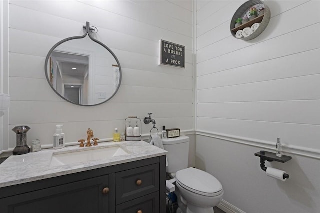 107 Falls Creek Ln, Gunter, TX 75058 - half bathroom featuring vanity, toilet, and wooden walls