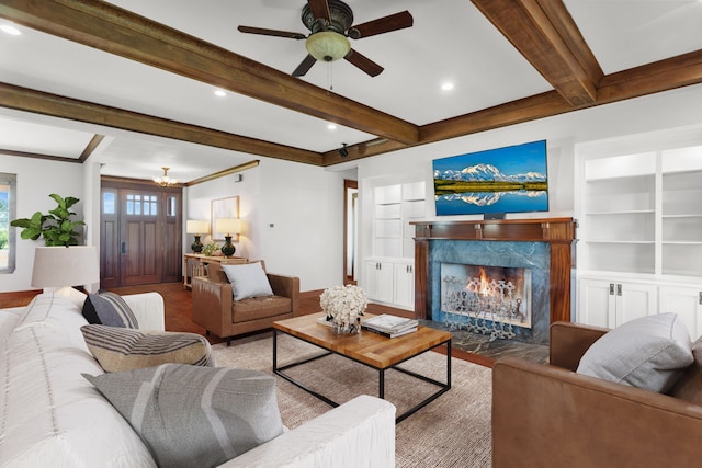 1206 Jc Maples Rd, Gunter, TX 75058 - living area featuring a premium fireplace, wood finished floors, a ceiling fan, built in features, and beam ceiling