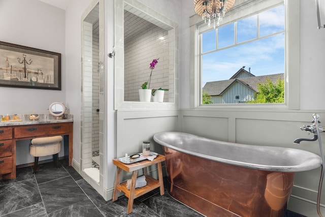 1206 Jc Maples Rd, Gunter, TX 75058 - full bathroom featuring marble look tile flooring, plenty of natural light, a soaking tub, wainscoting, and tiled shower