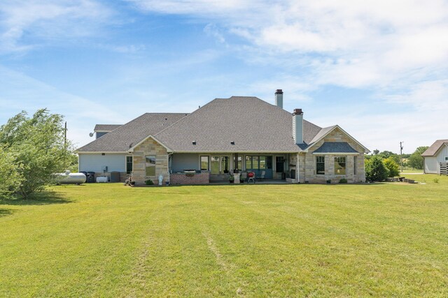 1206 Jc Maples Rd, Gunter, TX 75058 - rear view of property with a lawn, stone siding, a chimney, a patio area, and roof with shingles
