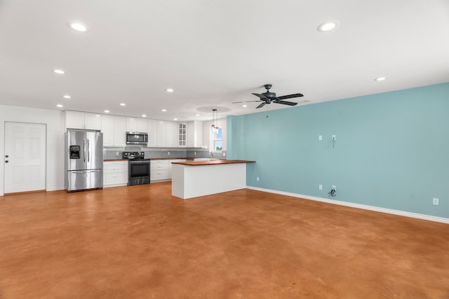 1206 Jc Maples Rd, Gunter, TX 75058 - kitchen featuring stainless steel appliances, recessed lighting, concrete flooring, baseboards, and glass insert cabinets