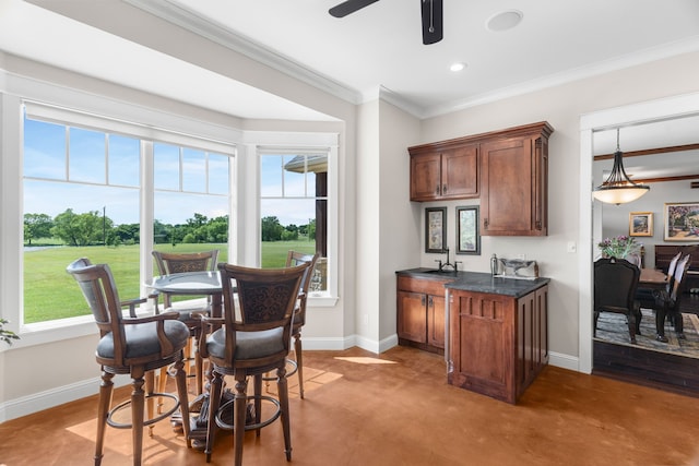 1206 Jc Maples Rd, Gunter, TX 75058 - kitchen featuring dark countertops, baseboards, crown molding, healthy amount of natural light, and recessed lighting
