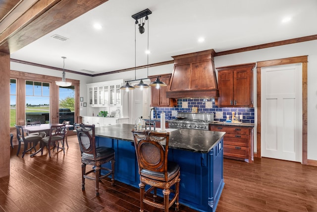 1206 Jc Maples Rd, Gunter, TX 75058 - kitchen with premium range hood, stove, an island with sink, backsplash, and dark wood-style floors