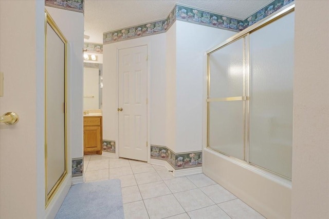 607 Dogwood Cir, Powderly, TX 75473 - full bathroom with tile patterned floors, vanity, shower / bath combination with glass door, and a textured ceiling