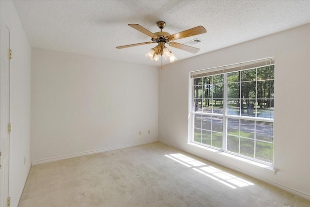 607 Dogwood Cir, Powderly, TX 75473 - carpeted spare room with healthy amount of natural light, a textured ceiling, ceiling fan, and baseboards