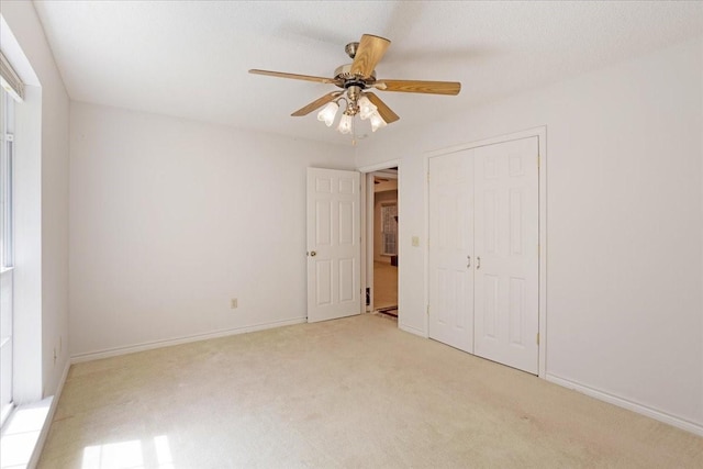 607 Dogwood Cir, Powderly, TX 75473 - unfurnished bedroom with light carpet, a closet, a ceiling fan, and baseboards