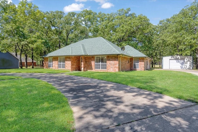 607 Dogwood Cir, Powderly, TX 75473 - ranch-style house with an outbuilding, driveway, a front lawn, brick siding, and roof with shingles