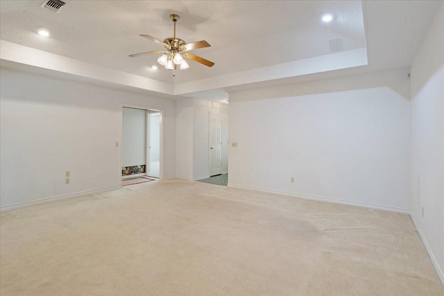 607 Dogwood Cir, Powderly, TX 75473 - spare room with a ceiling fan, a raised ceiling, light colored carpet, baseboards, and recessed lighting