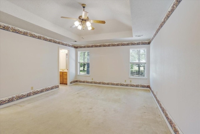 607 Dogwood Cir, Powderly, TX 75473 - empty room featuring healthy amount of natural light, light carpet, a tray ceiling, and baseboards