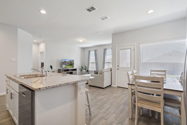 8580 Big Apple Dr, Fort Worth, TX 76179 - kitchen with a sink, light wood-style floors, dishwasher, white cabinets, and recessed lighting