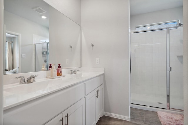8580 Big Apple Dr, Fort Worth, TX 76179 - bathroom featuring a stall shower, double vanity, wood finished floors, and baseboards