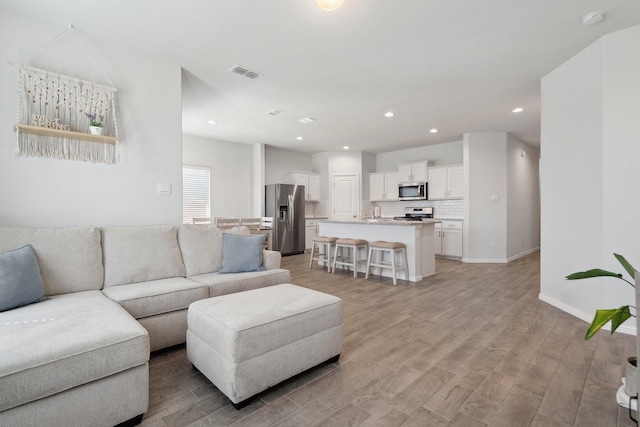 8580 Big Apple Dr, Fort Worth, TX 76179 - living room featuring light wood-style floors, baseboards, and recessed lighting