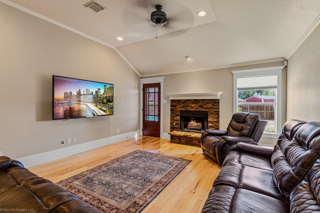 118 Lightning Trl, Forney, TX 75126 - living area featuring vaulted ceiling, a ceiling fan, wood finished floors, ornamental molding, and a stone fireplace