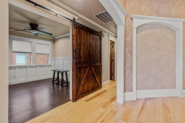118 Lightning Trl, Forney, TX 75126 - hall featuring a barn door, hardwood / wood-style flooring, crown molding, and a wainscoted wall
