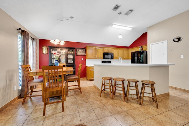 dining room with lofted ceiling, light tile patterned floors, a chandelier, and baseboards