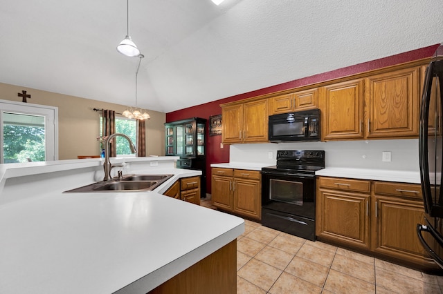 kitchen with black appliances, a sink, light countertops, brown cabinetry, and vaulted ceiling