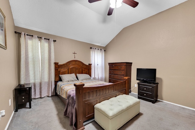 bedroom featuring lofted ceiling, light carpet, baseboards, and ceiling fan