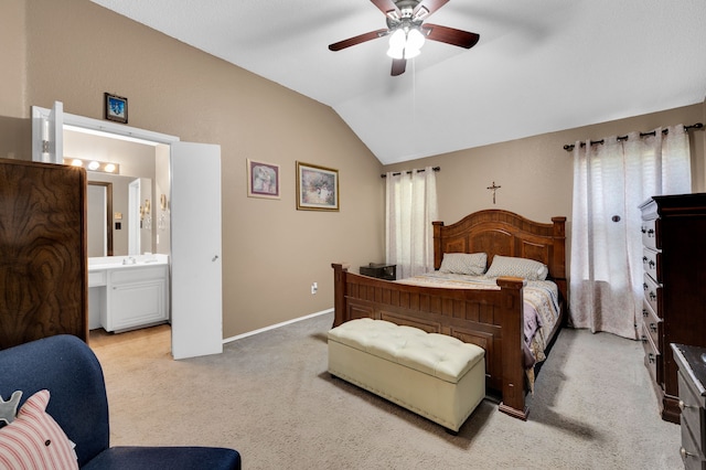 bedroom with vaulted ceiling, light colored carpet, connected bathroom, baseboards, and ceiling fan