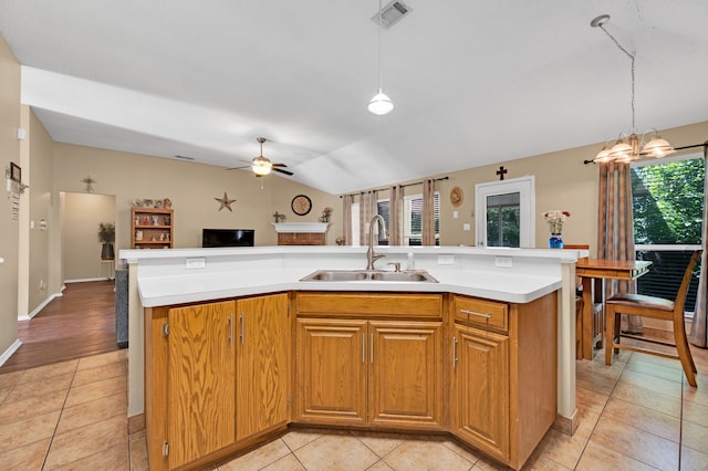 kitchen featuring a sink, plenty of natural light, open floor plan, light countertops, and lofted ceiling